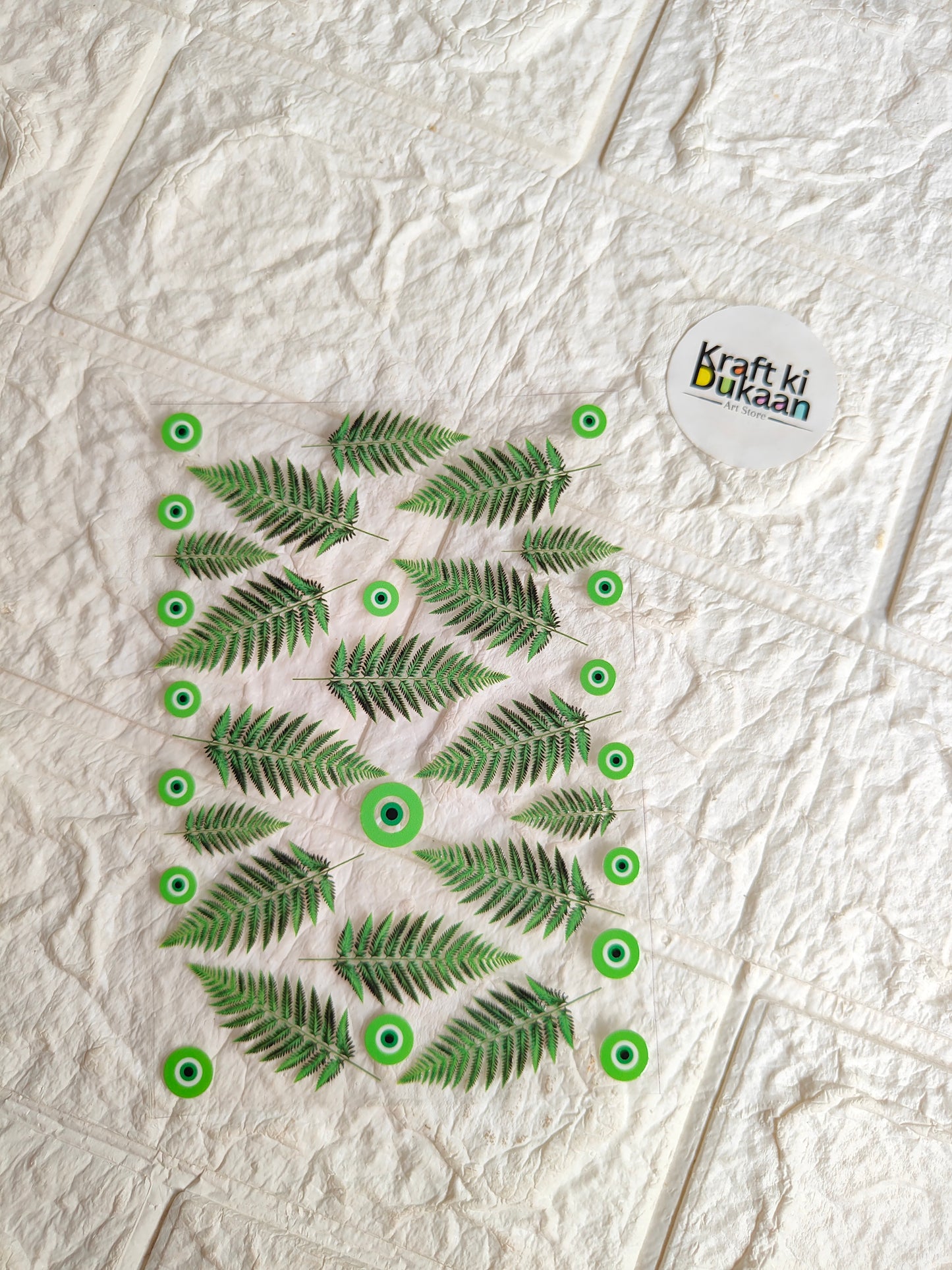 Peel-off sticker sheet with green tropical fern leaf designs and round backing holes