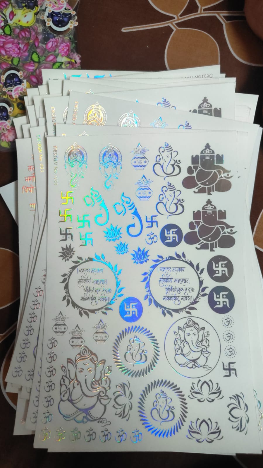 Holographic sticker sheet with blue and silver fantasy symbols and faces