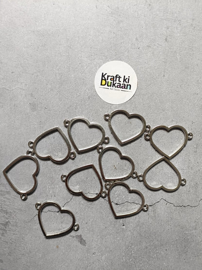 Set of silver-tone heart bezel charm bracelets, several hearts laid flat