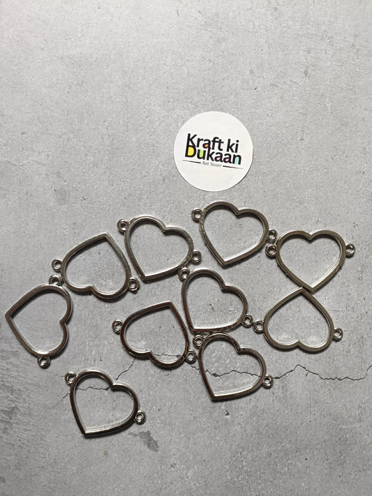 Set of silver-tone heart bezel charm bracelets, several hearts laid flat