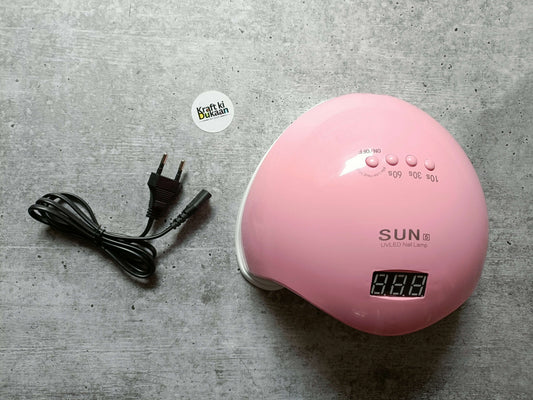 Pink UV LED nail lamp with digital timer display and round control buttons