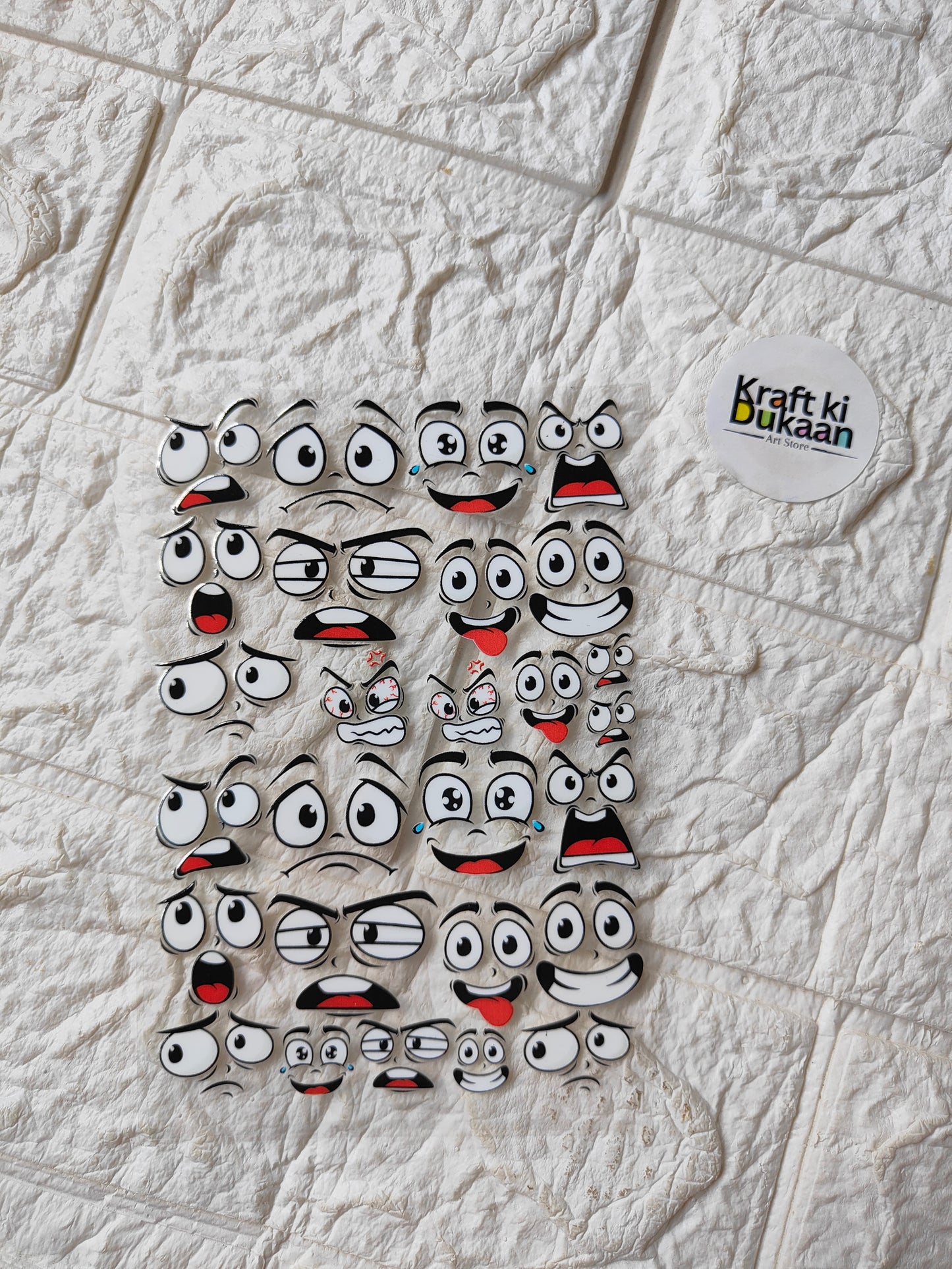 Peel-off sticker sheet with cartoon face characters, multiple expressions and red accents