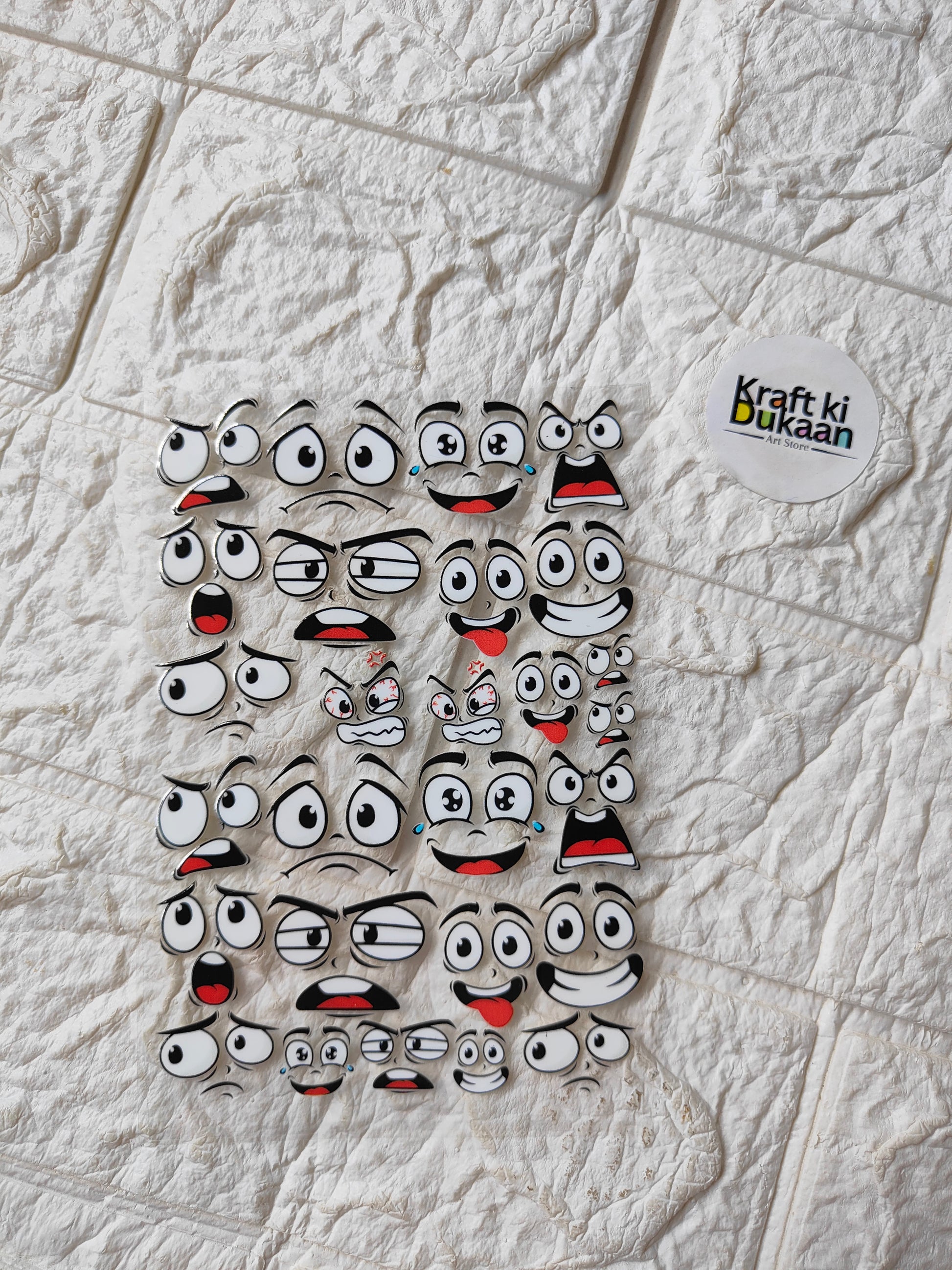 Peel-off sticker sheet with cartoon face characters, multiple expressions and red accents