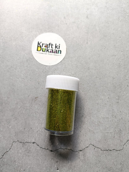 Olive green chunky glitter powder jar with white lid.