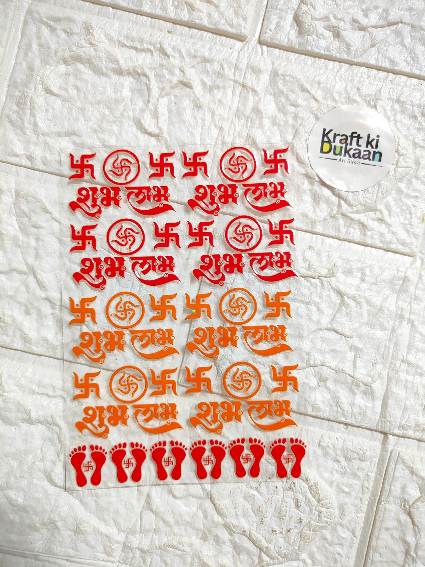 Decorative sticker sheet with red and orange Diwali symbols and footprints, peel-off