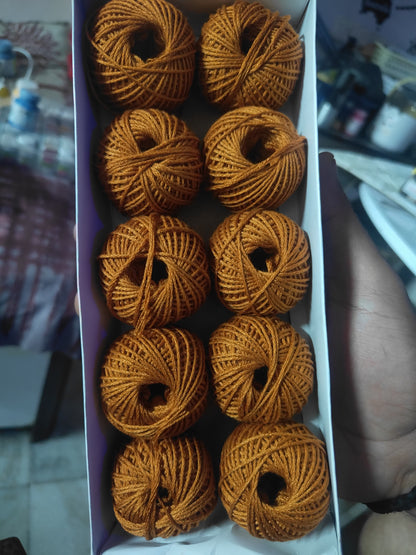 Rakhi thread roll set with brown yarn balls in an open cardboard box