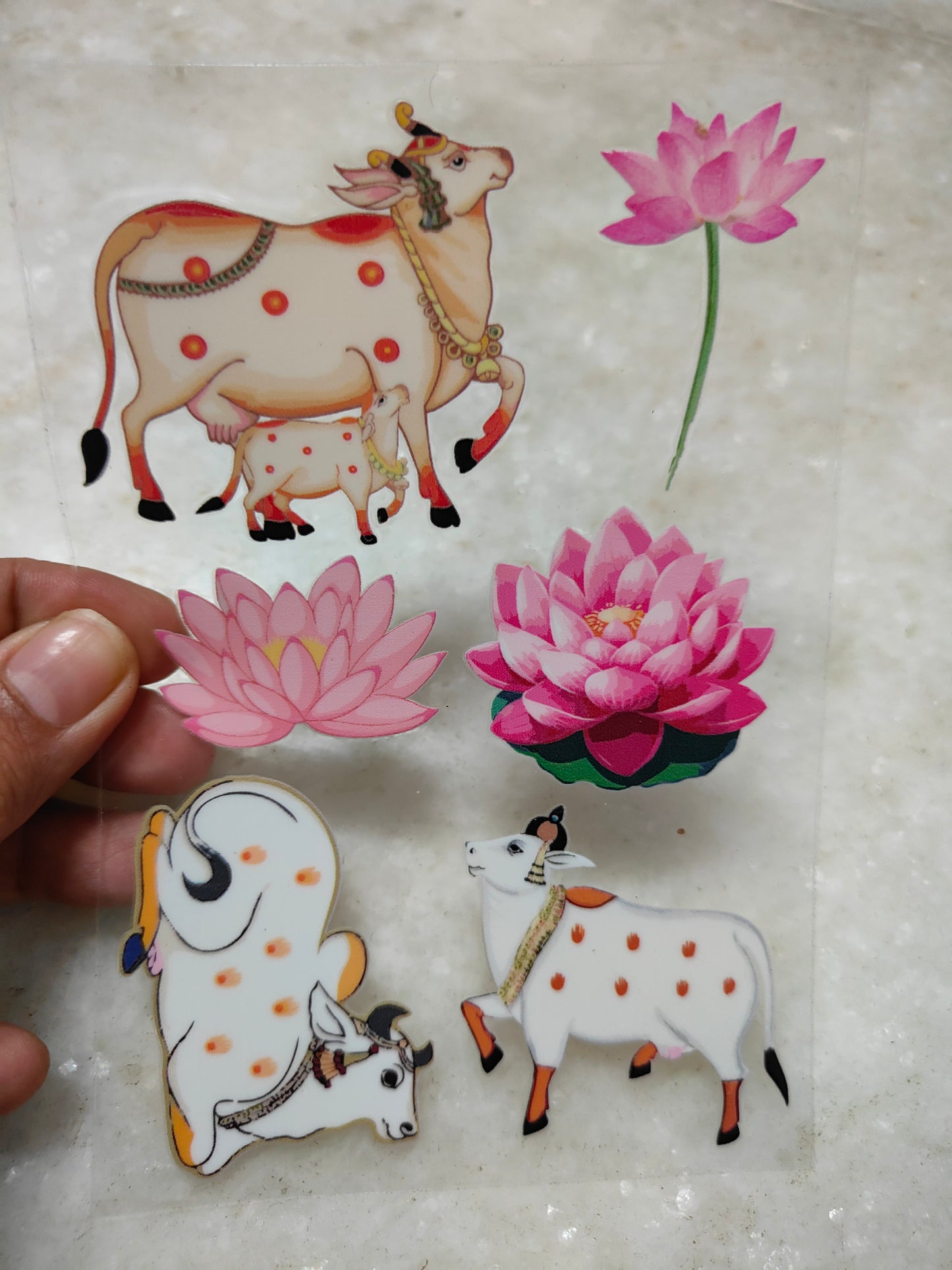 Peel-off sticker sheet with pink lotus flowers and white cow figures