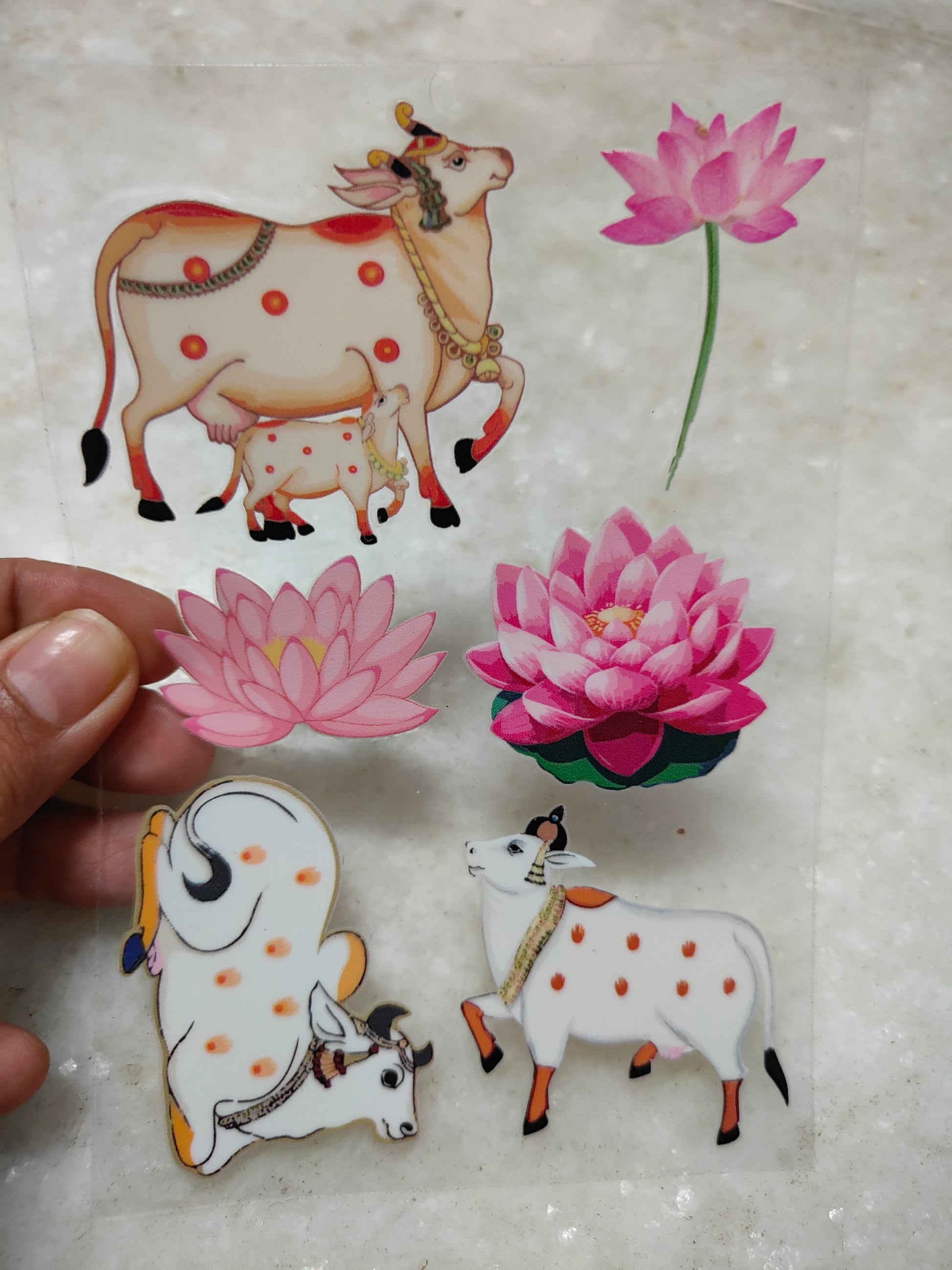 Peel-off sticker sheet with pink lotus flowers and white cow figures