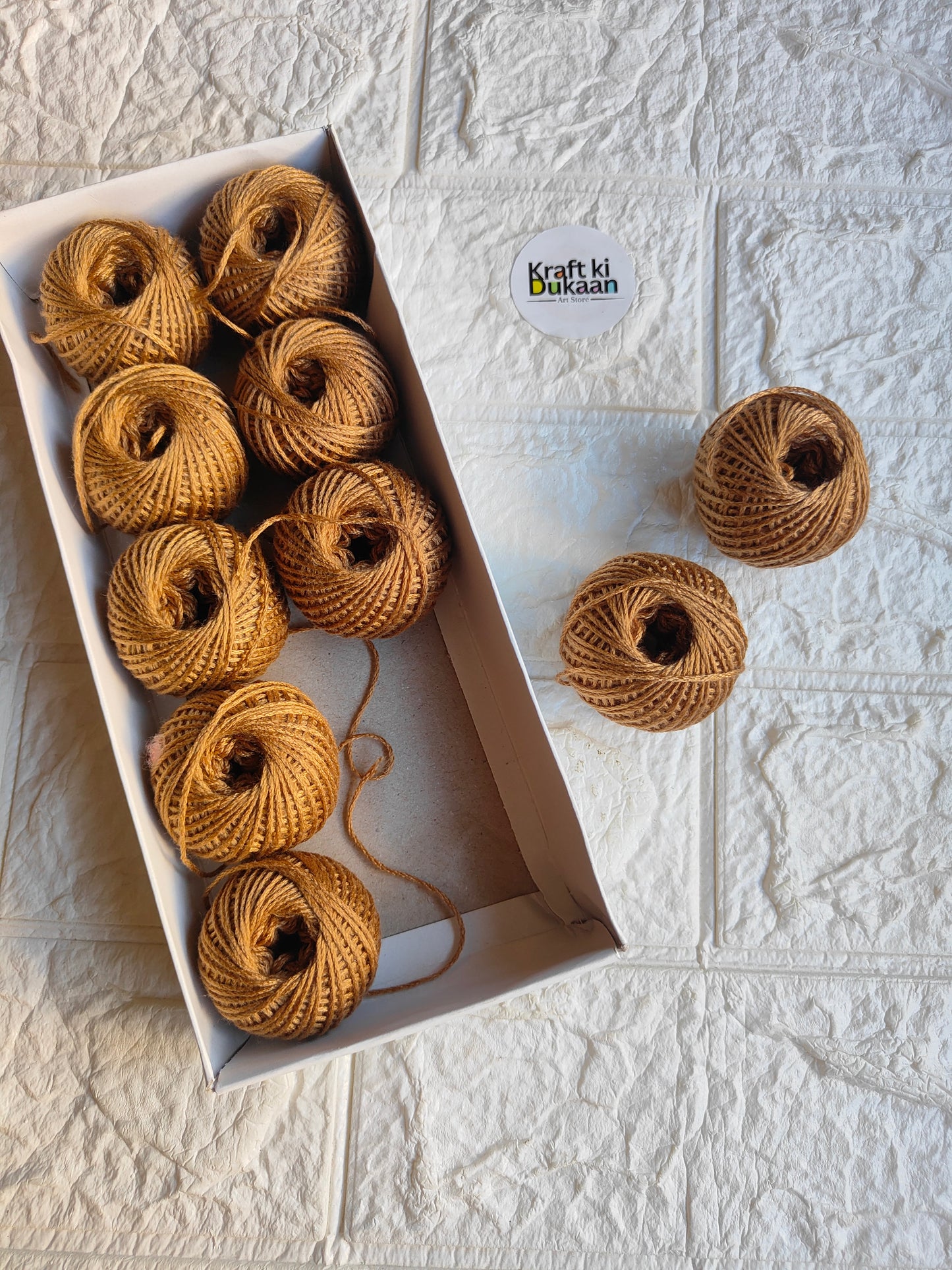 Rakhi thread roll set, tan-brown yarn balls with loose thread ends