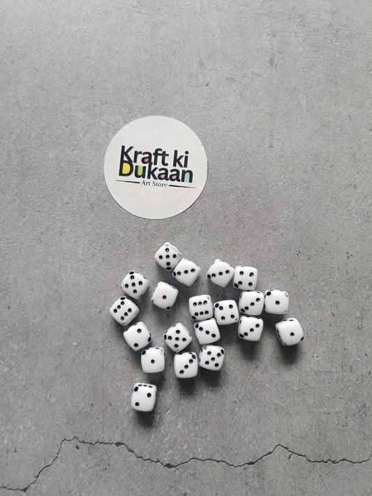 Rakhi bracelet beads pack: white dice beads with black dots, scattered