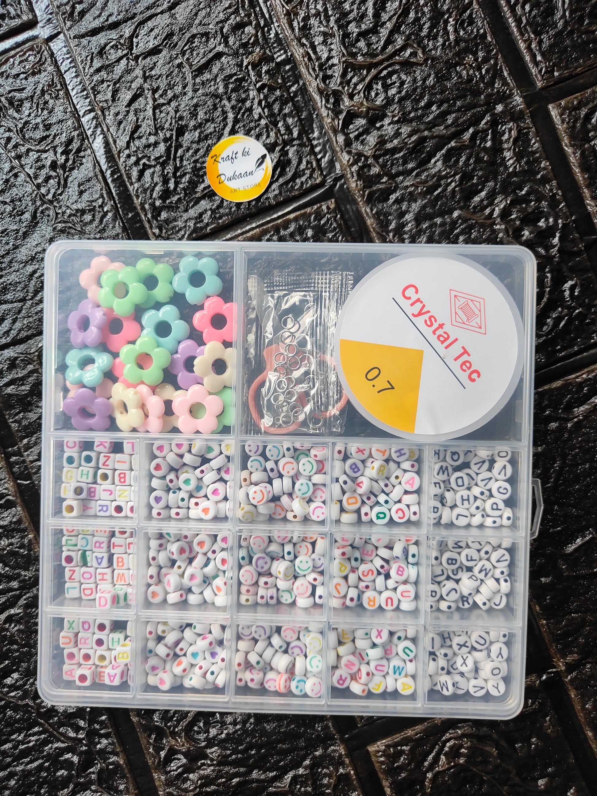 DIY bracelet beads kit: clear divided box with letter and flower beads, cord and clasps