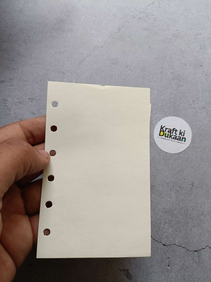 Hand holding cream note pages with punched holes, 8.3x13cm