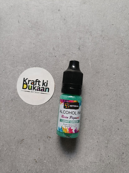 Alcohol ink bottle with black cap, light green resin pigment label