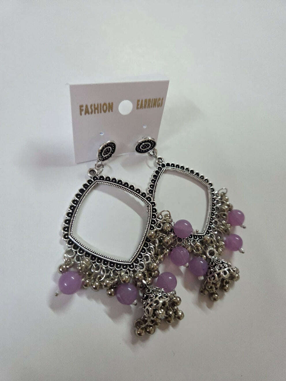 Square jhumka earrings with lavender/purple beads and silver-tone bell tassels