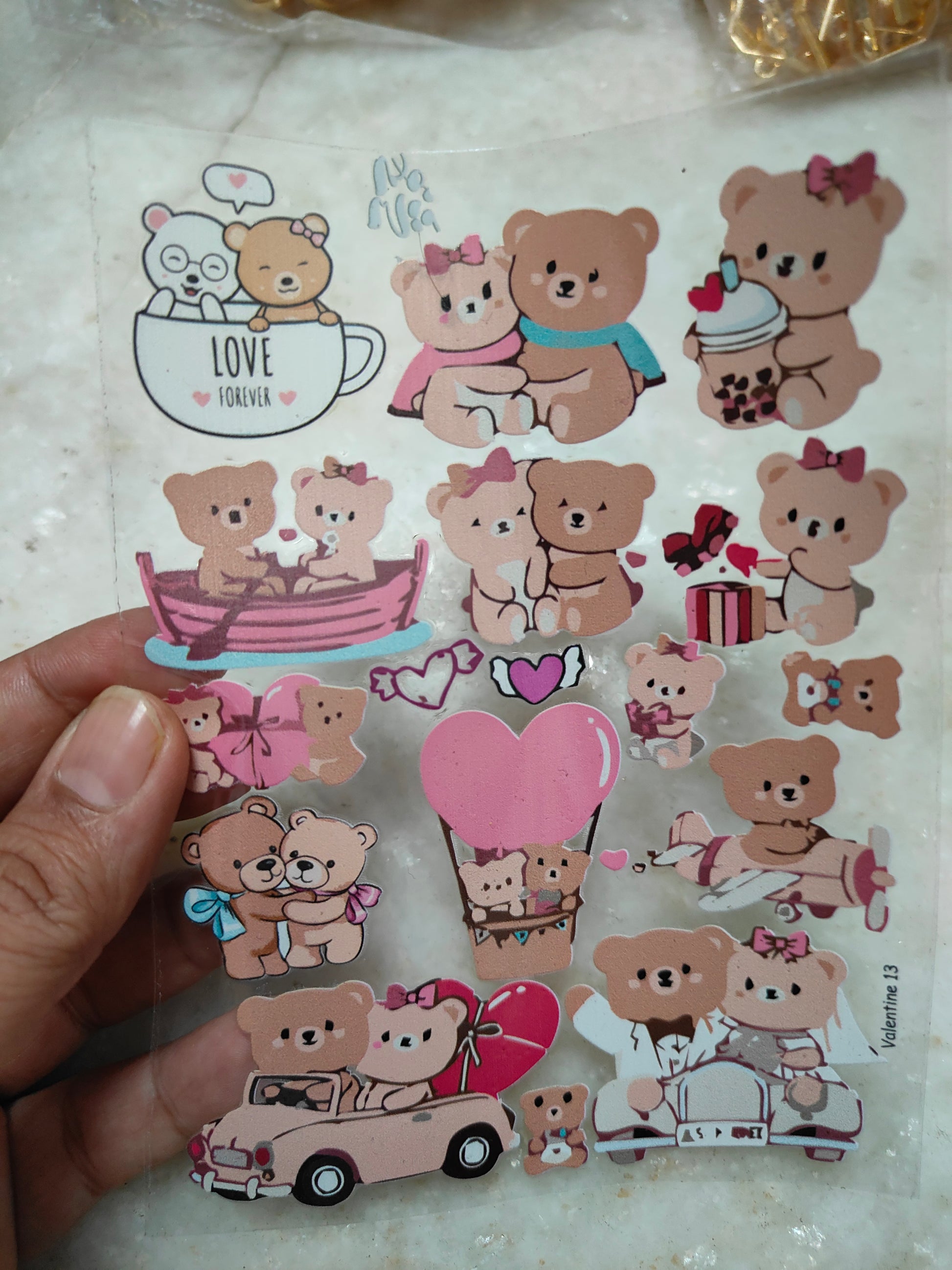 Peel-off sticker sheet with cute bear characters, hearts, and small scenes