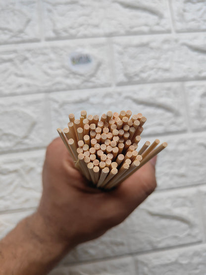 Bundle of bamboo chopsticks held in hand, textured ends with dots