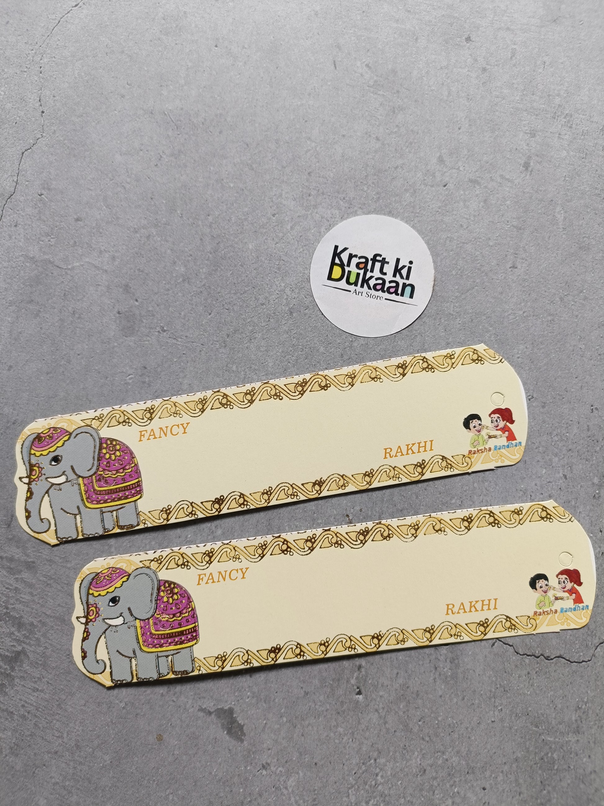 Rakhi cards pack of 12 A9, gold border with elephant and kids, 'Rakhi' text.