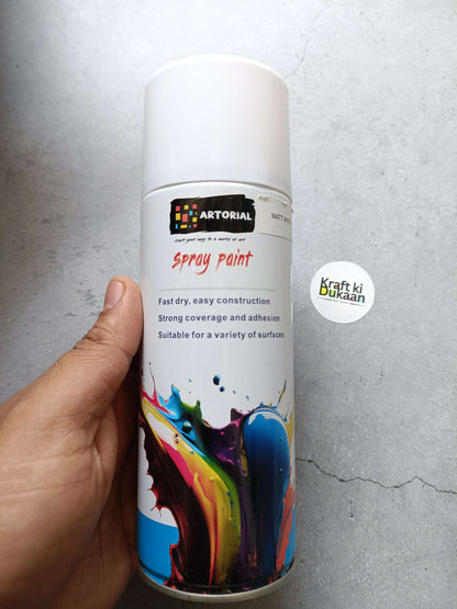 White spray paint can with colorful front label and cap