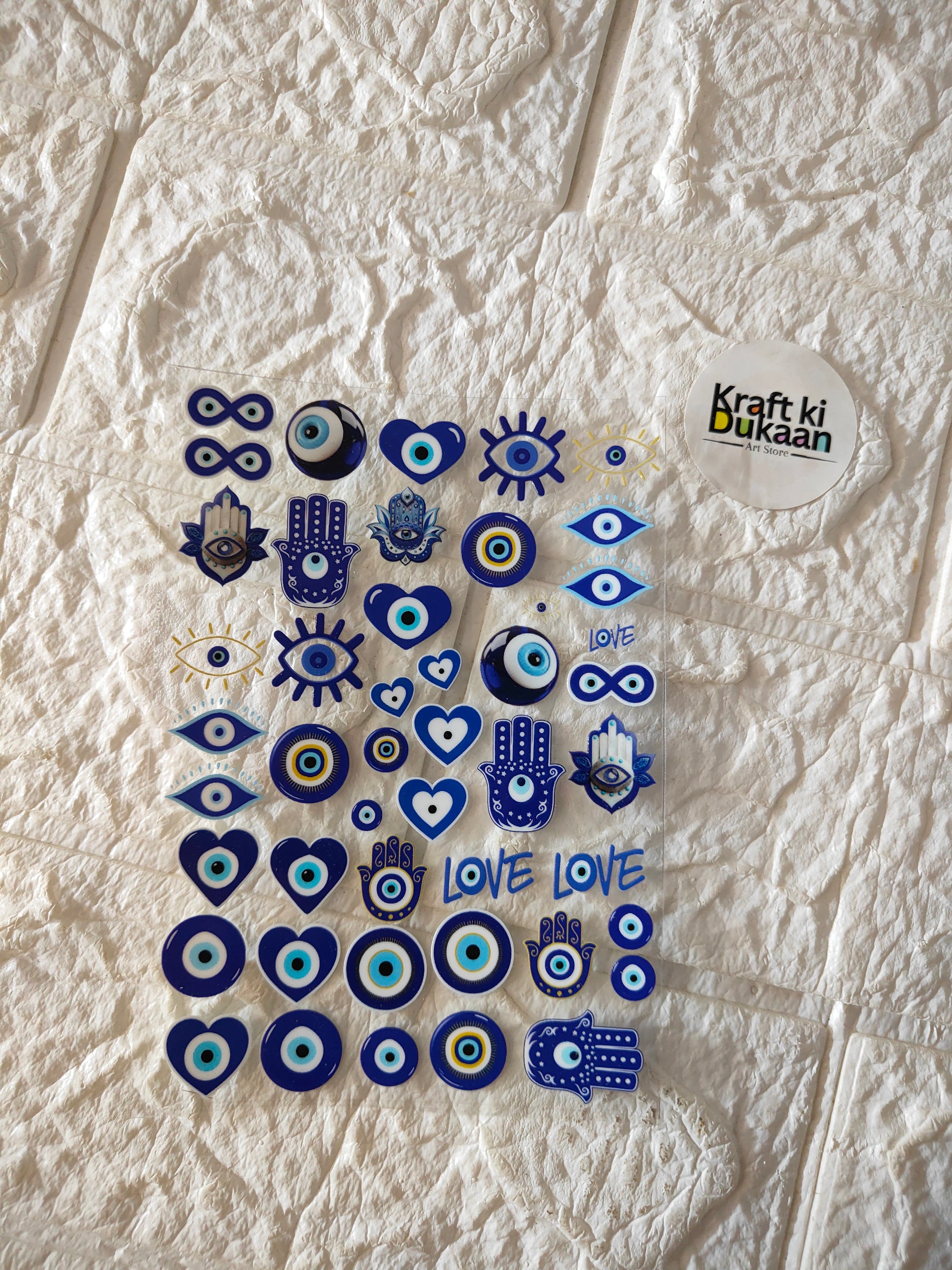 UV DTF peel-off sticker sheet with blue evil eye and heart designs