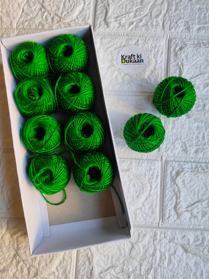 Rakhi thread roll with green yarn balls in an open box and one loose ball