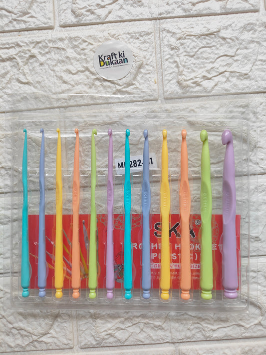 Plastic crochet hook set with 12 assorted color hooks, laid out