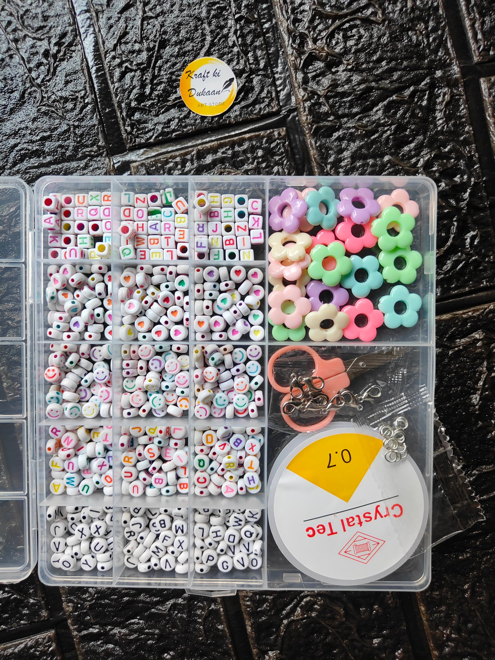 DIY bracelet beads kit: clear box of letter beads, flower beads, and chain/clasps accessories