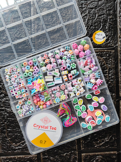 DIY bracelet beads kit open in clear tray with assorted beads, alphabet charms, and thread