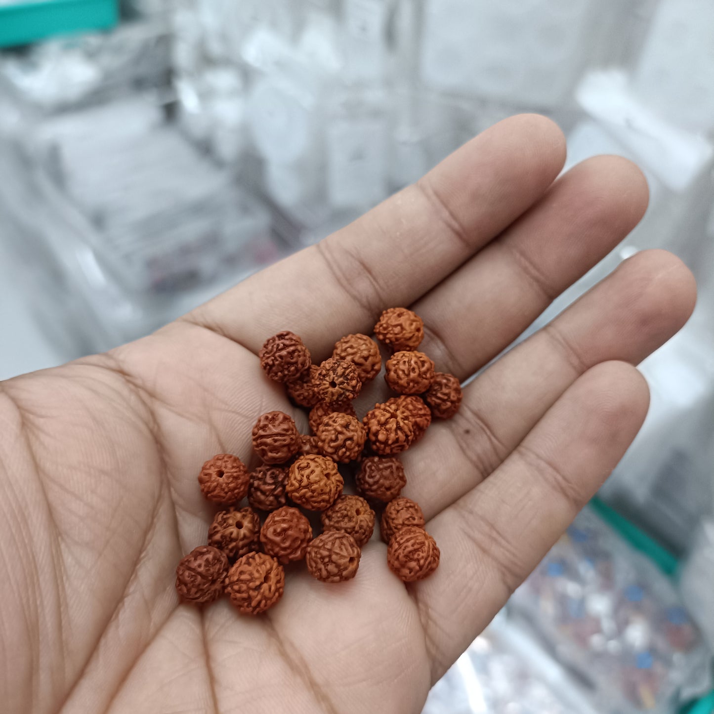 Brown carved wooden rudraksh beads in hand, round 8–10 mm size