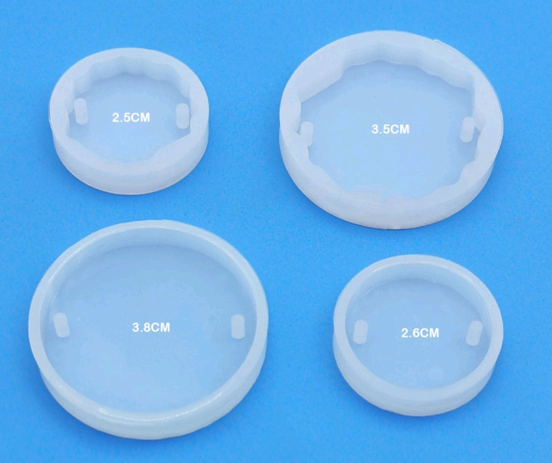 Set of four round translucent silicone rakhi molds with size markings on cavities