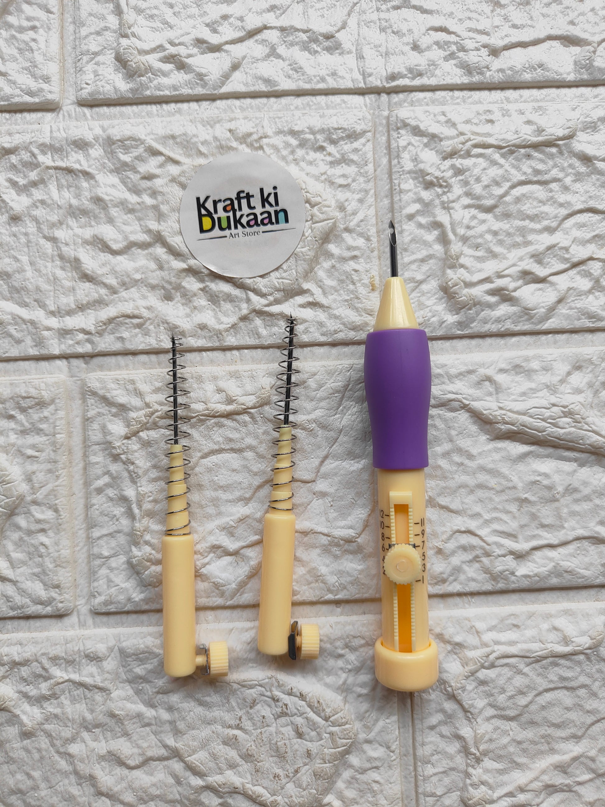 Punch needle set with purple and beige handle tools and multiple needle loops