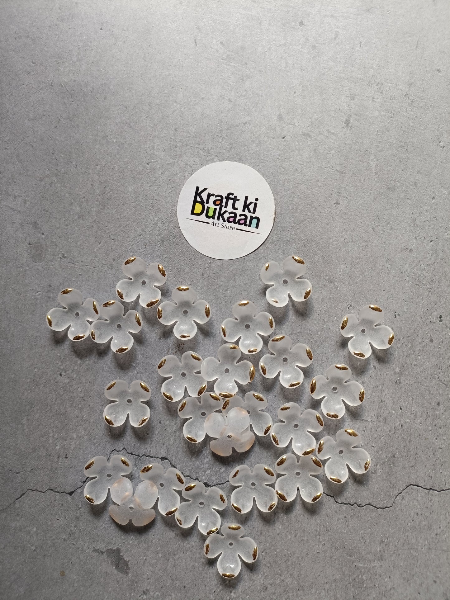White flower beads, scattered display of petal-shaped beads; pack of 50