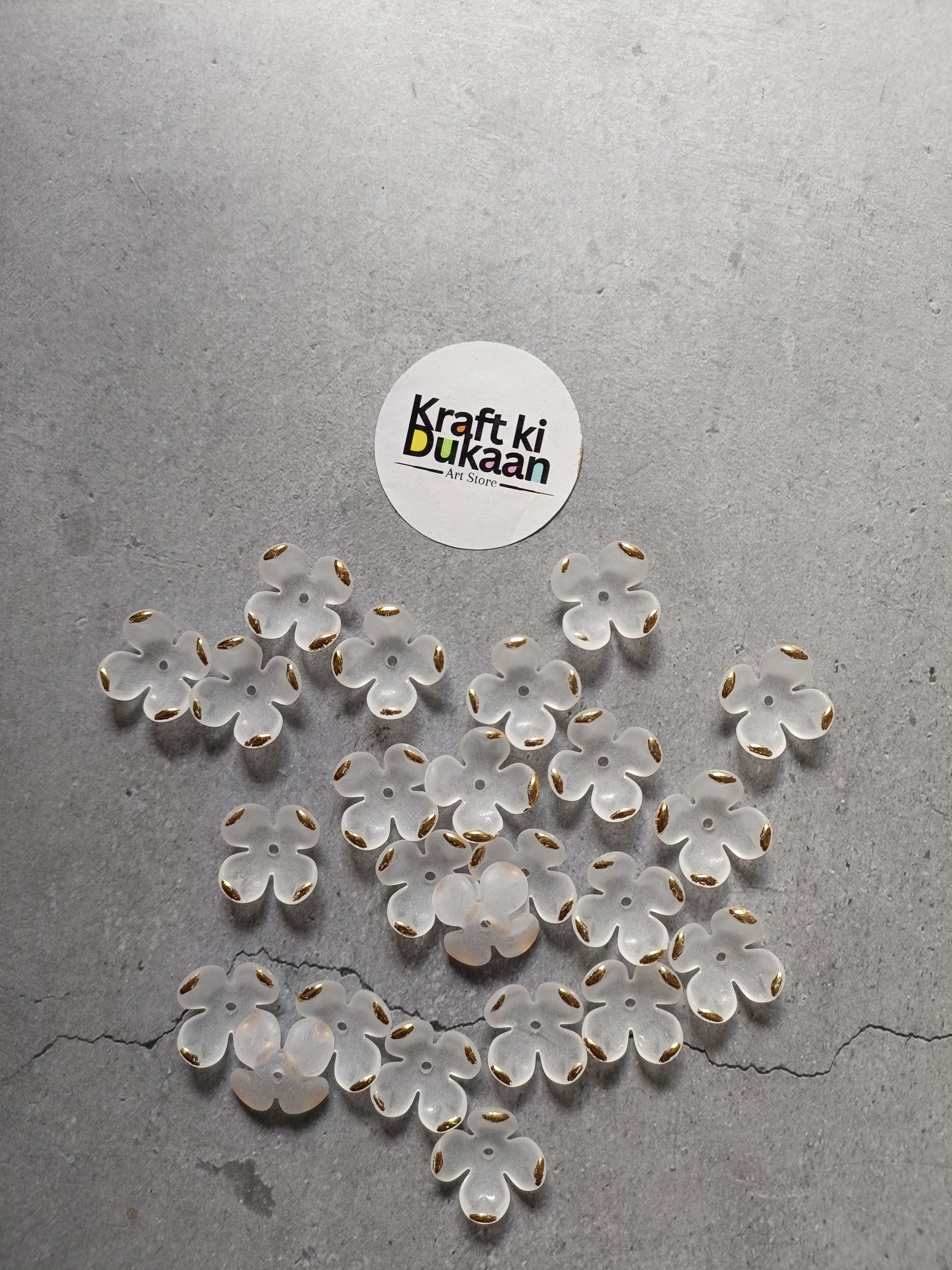 White flower beads, scattered display of petal-shaped beads; pack of 50