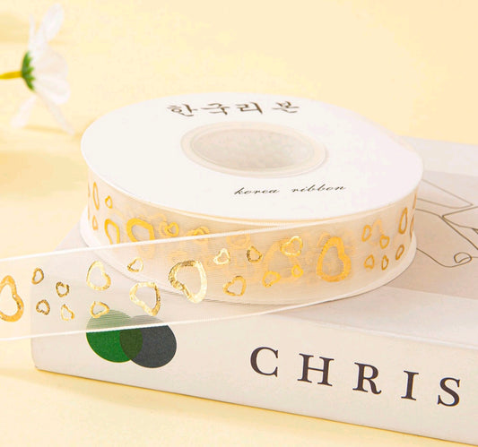 White ribbon spool with gold heart pattern print, 2.5 cm wide