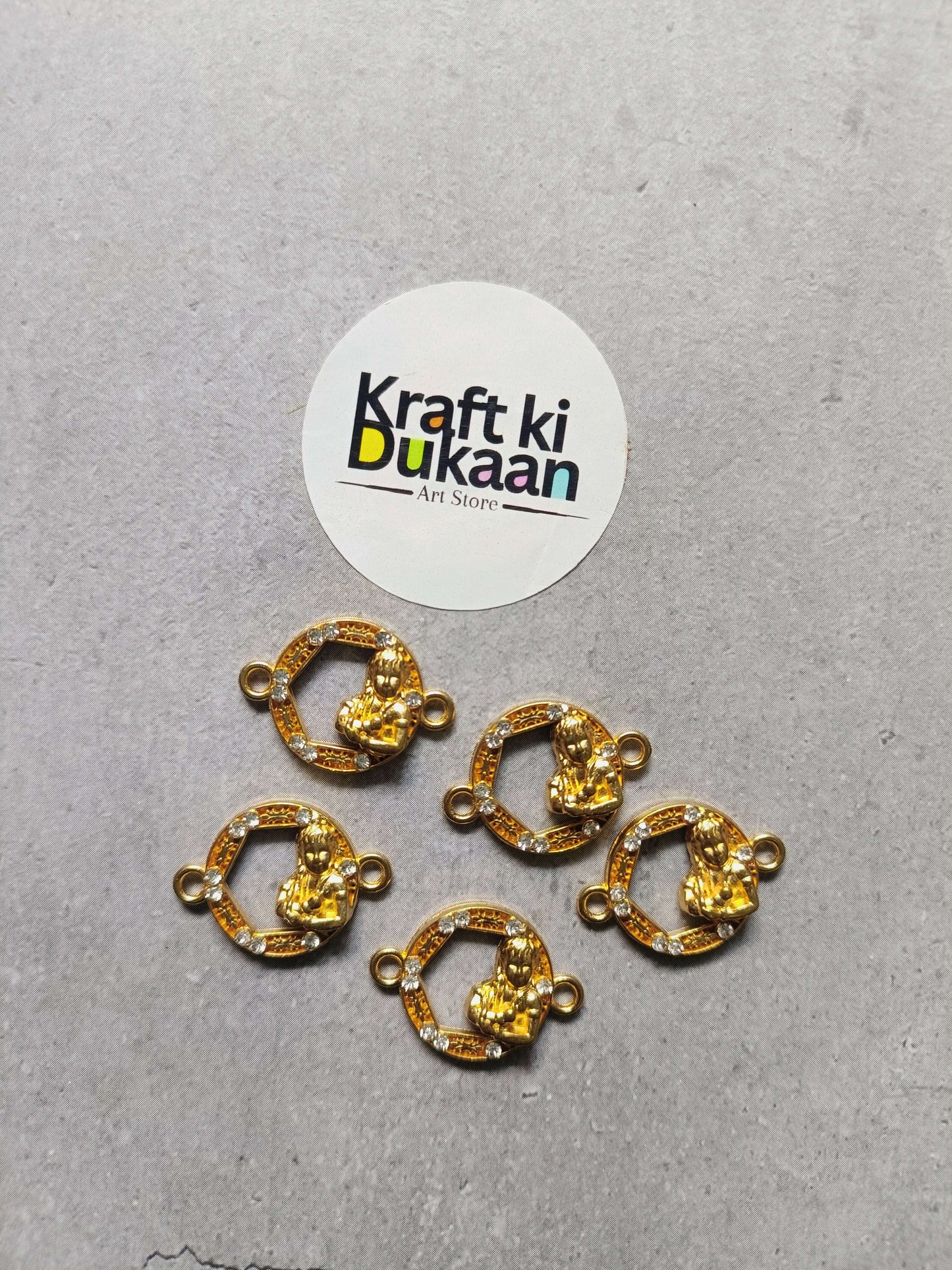 Set of round gold-toned bezel rakhi bracelet charms with rhinestone border and side loops