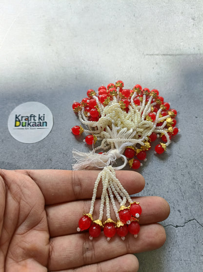 Red bead tassel latkan with white thread and gold accents