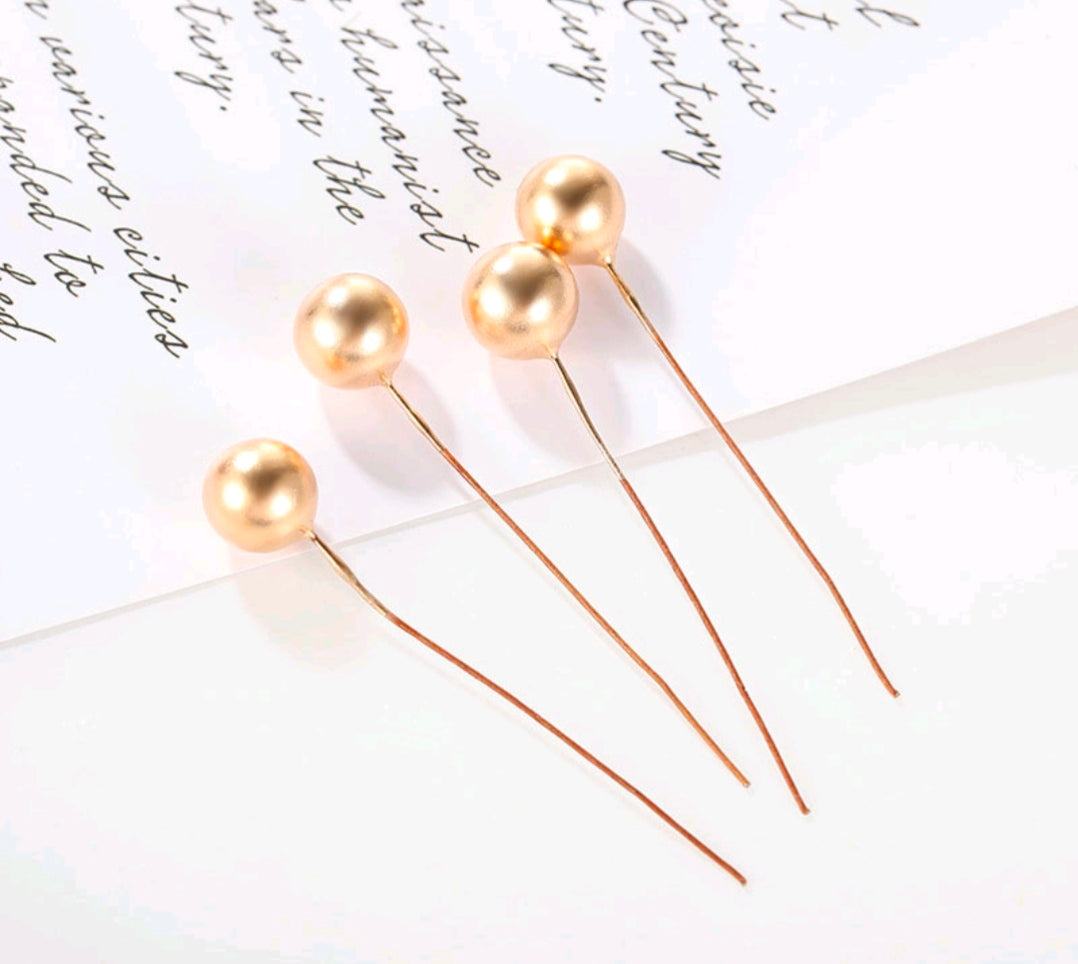 Gold faux pearl ball topper picks on thin stems, close-up set of three