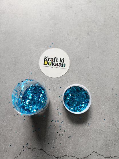 Hexagon-shaped glitter containers with blue glitter flakes, two round lids
