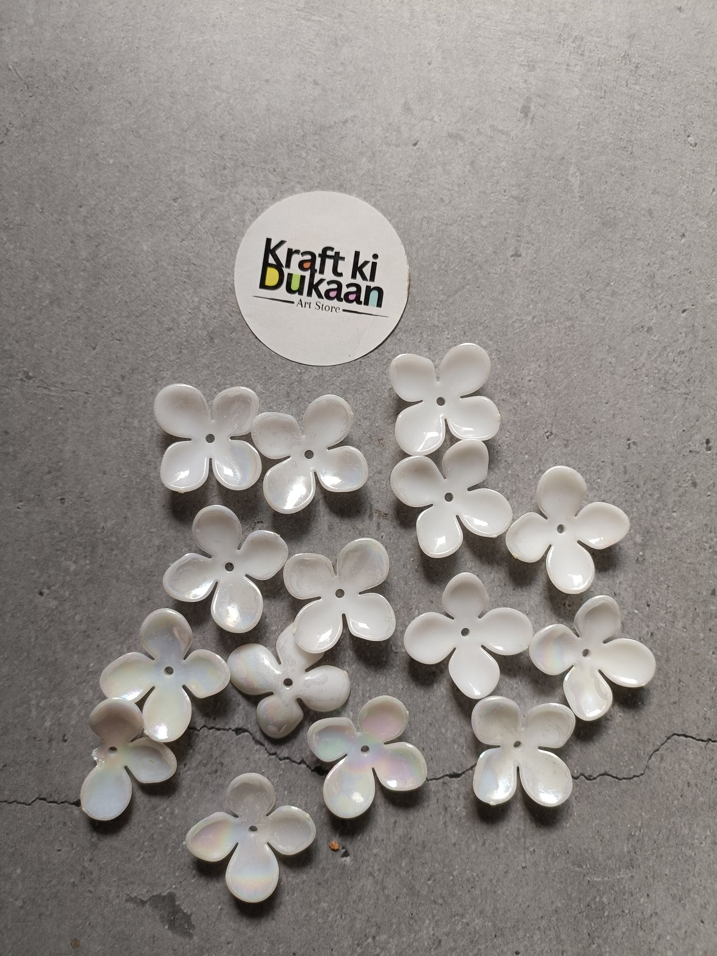 White 4-petal flower beads scattered