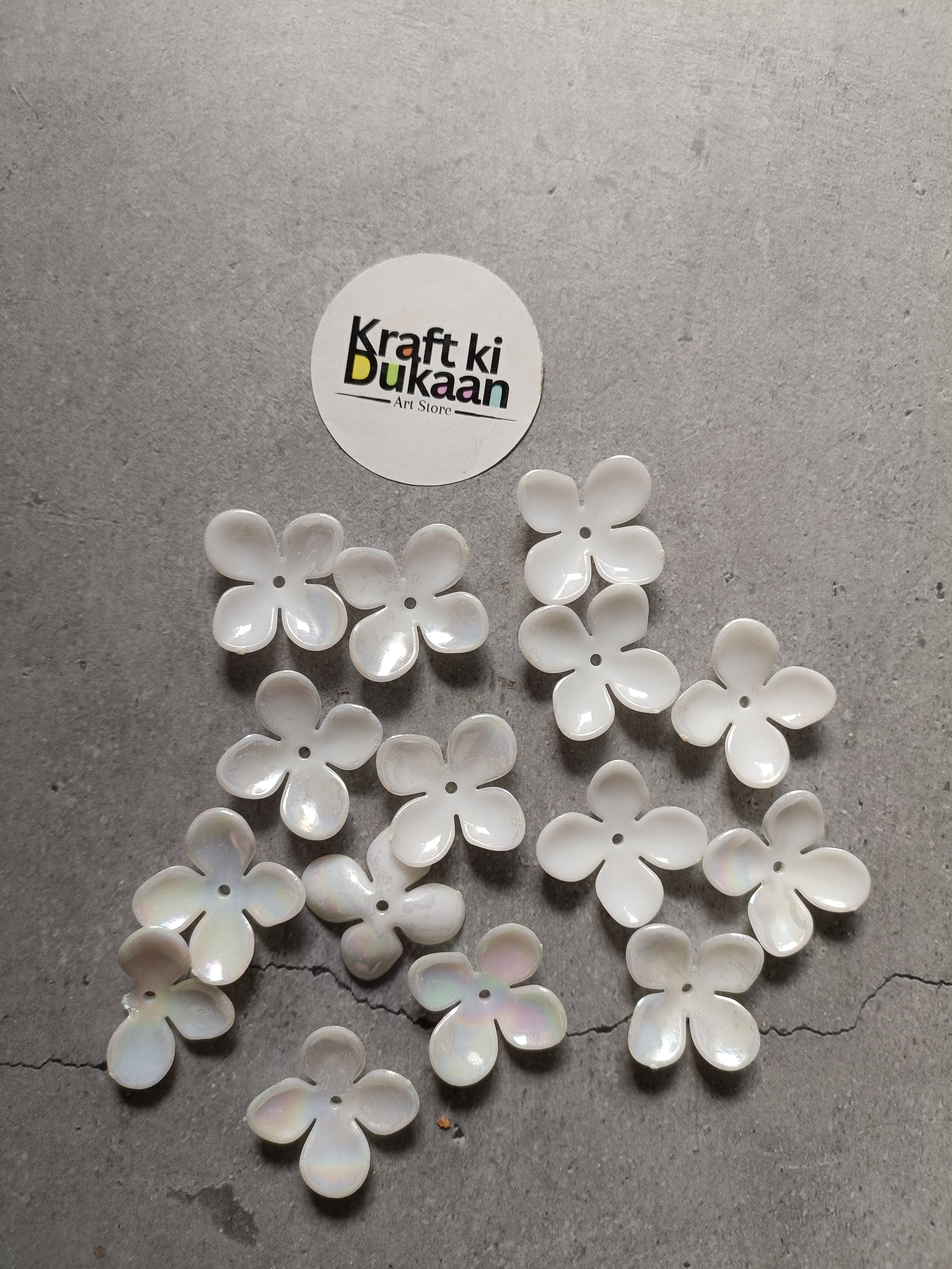White 4-petal flower beads scattered