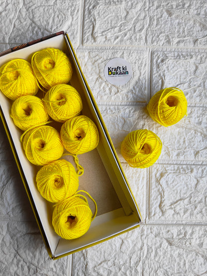 Rakhi thread roll with bright yellow-green thread balls in open box