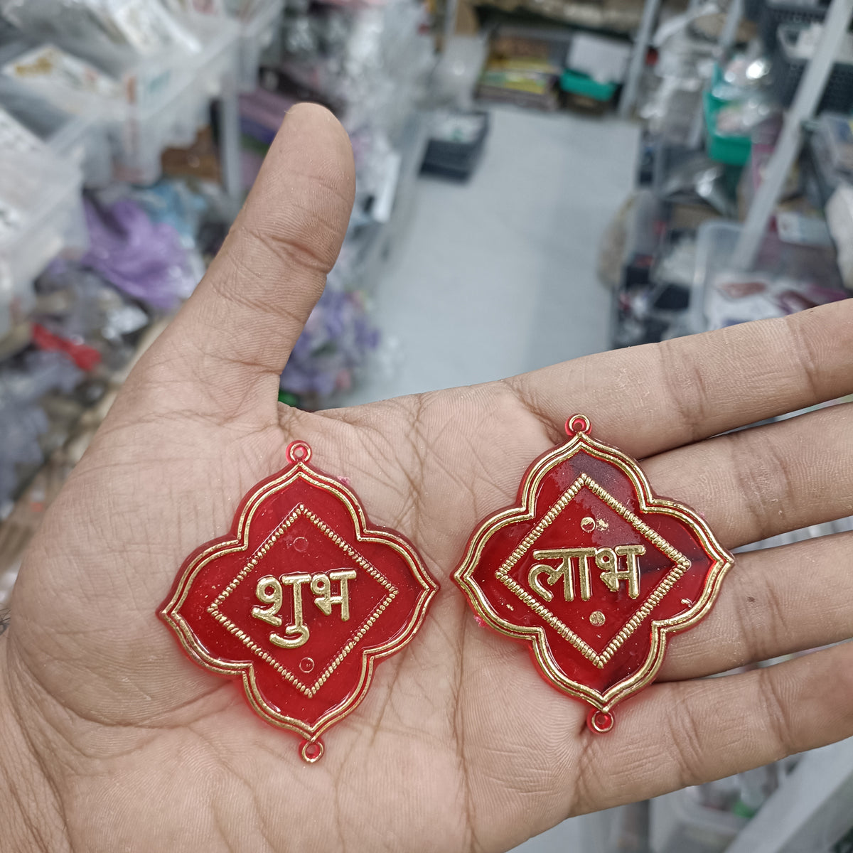 Red acrylic Shubh and Labh hanging ornaments with gold trim