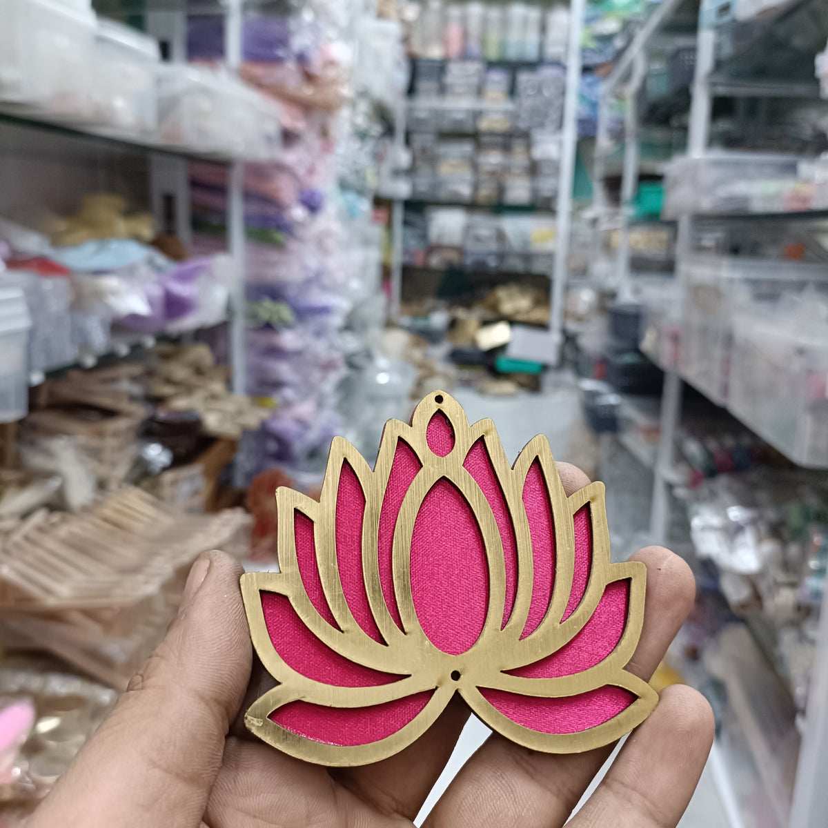 Rani pink lotus-shaped MDF cutout with scalloped petals and beige outline, handheld view