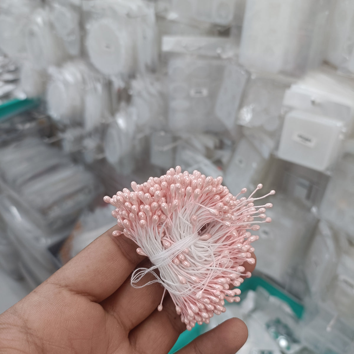 Artificial pollen bunch, pale pink and white bead-like florets on thin stems