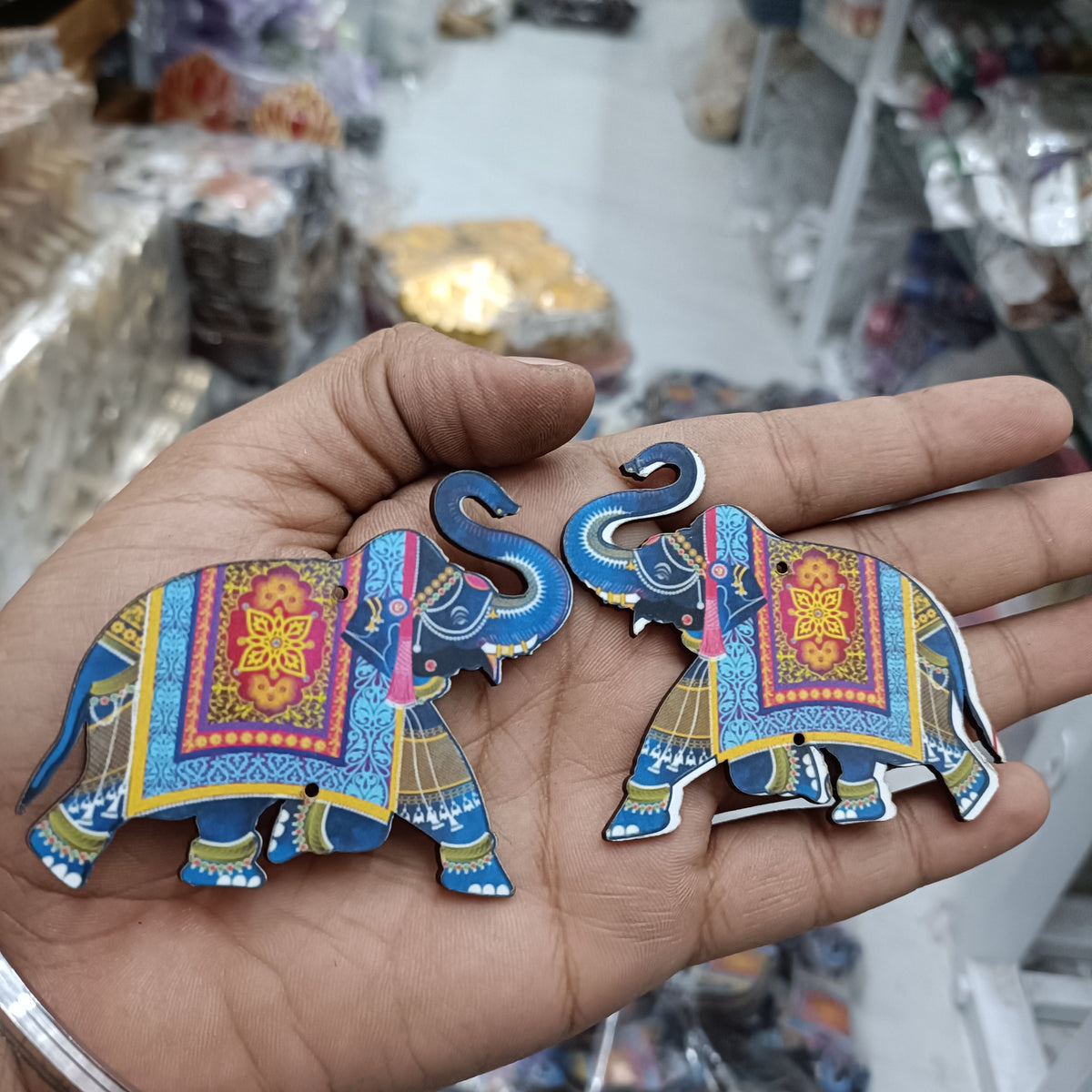Ornate blue MDF elephant cutouts pair, one side view with colorful border
