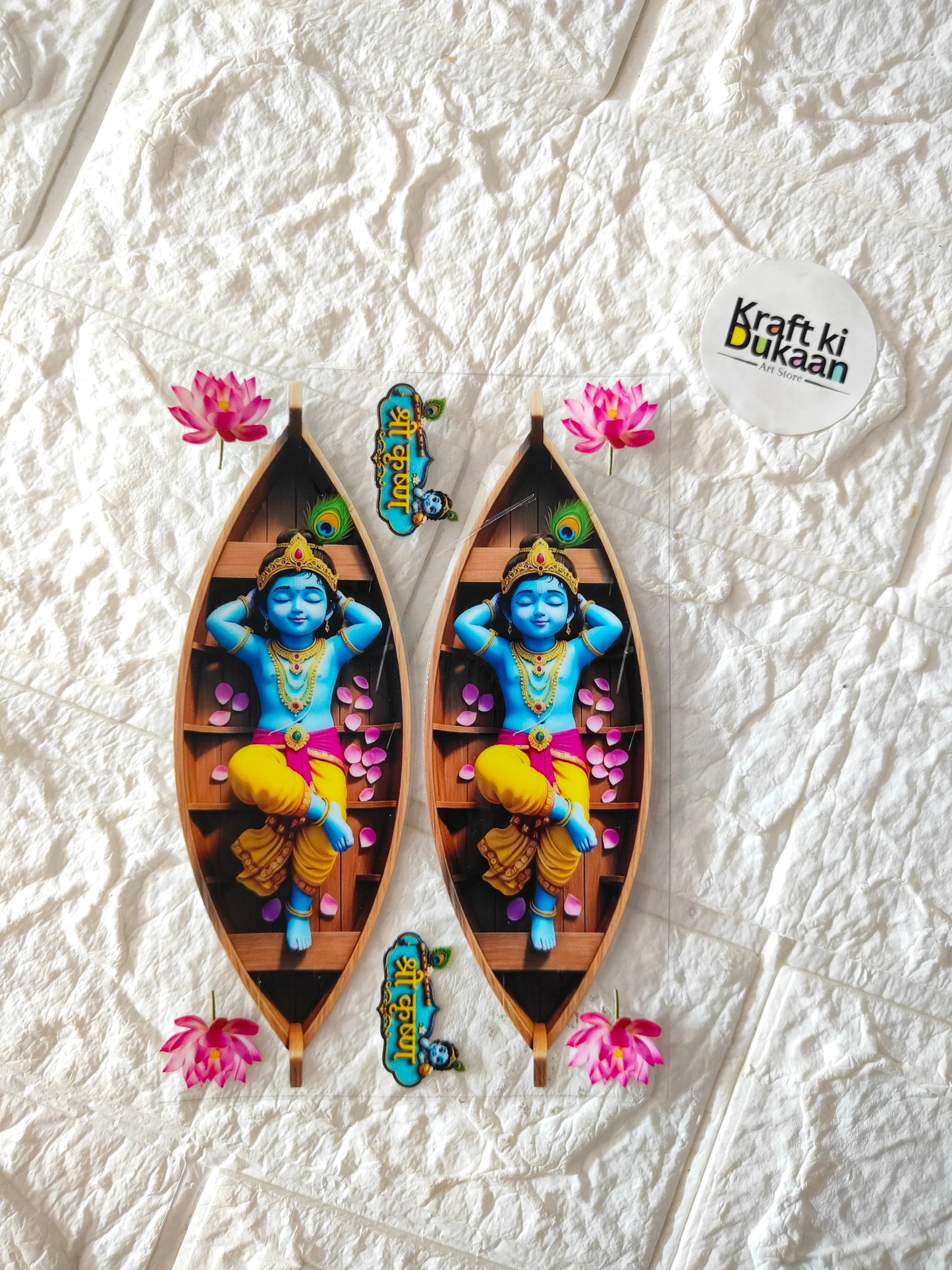 Peel-off sticker sheet with two colorful boat-shaped decals, blue figure and pink flowers