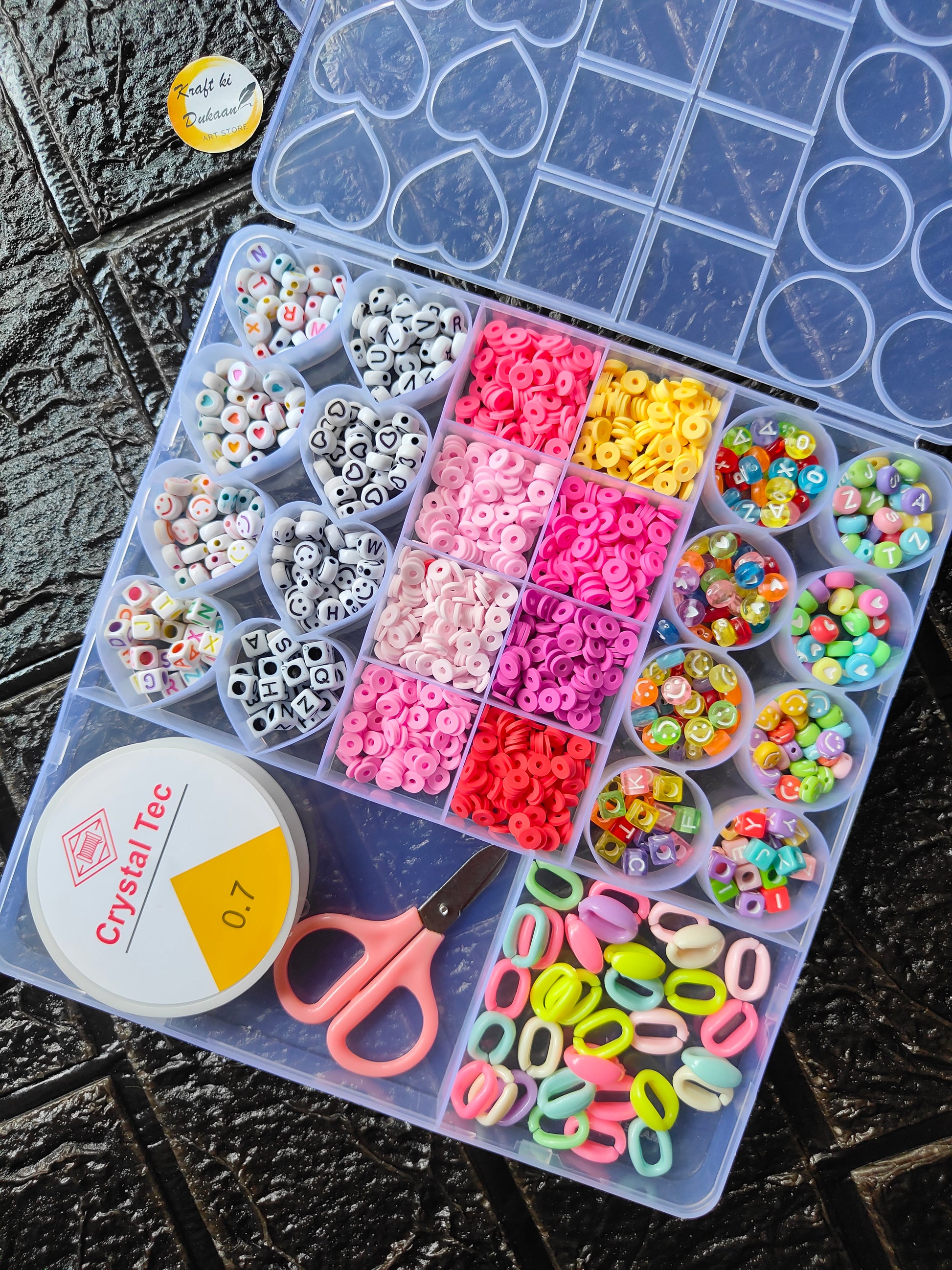 DIY bracelet beads kit with clear case of multicolor beads, heart charms, and scissors