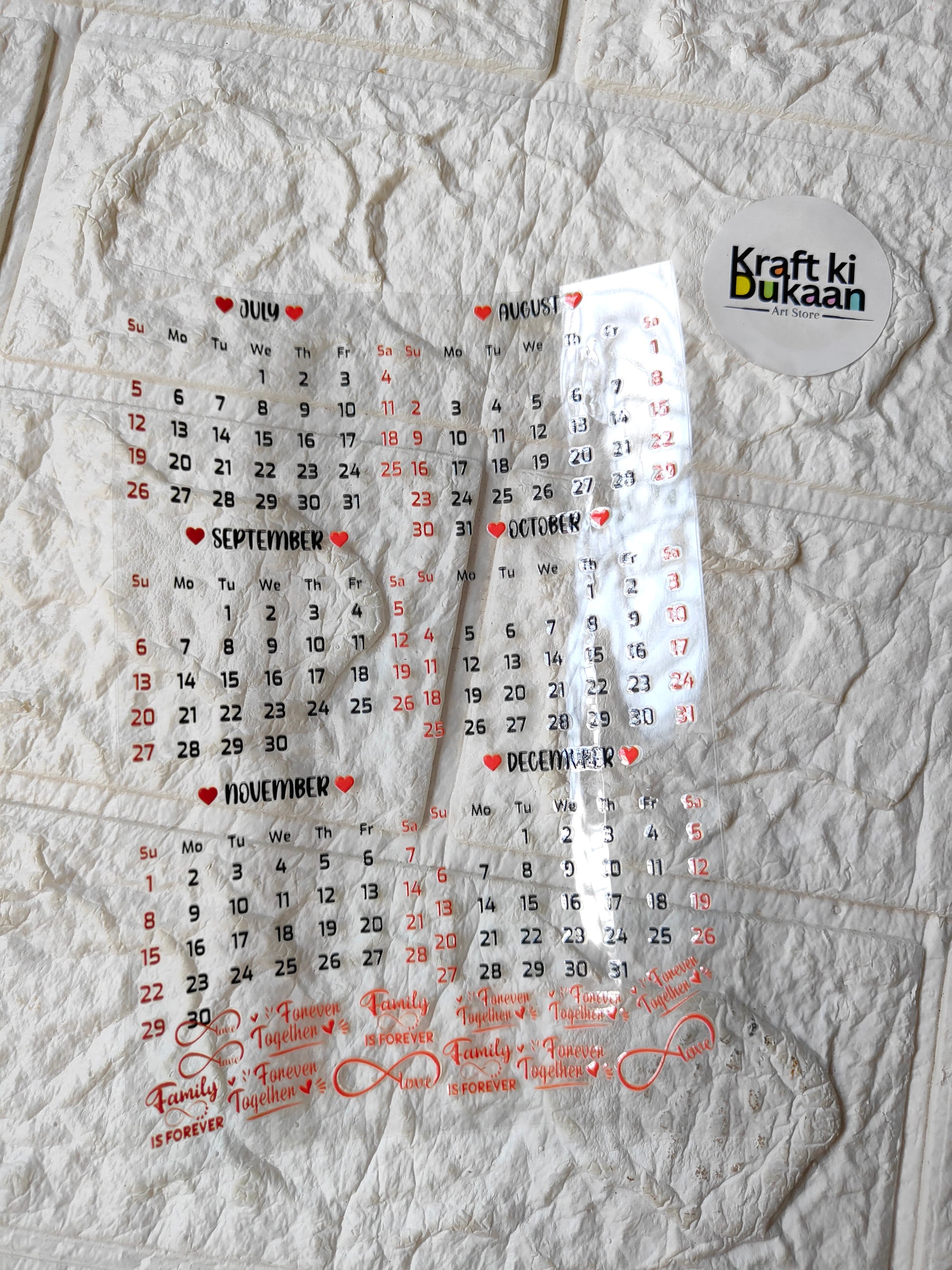 Calendar-themed peel-off sticker sheet with red and white text, numbers, and circles