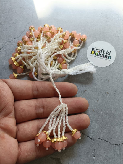 Peach bead tassel latkan with white thread and gold accents