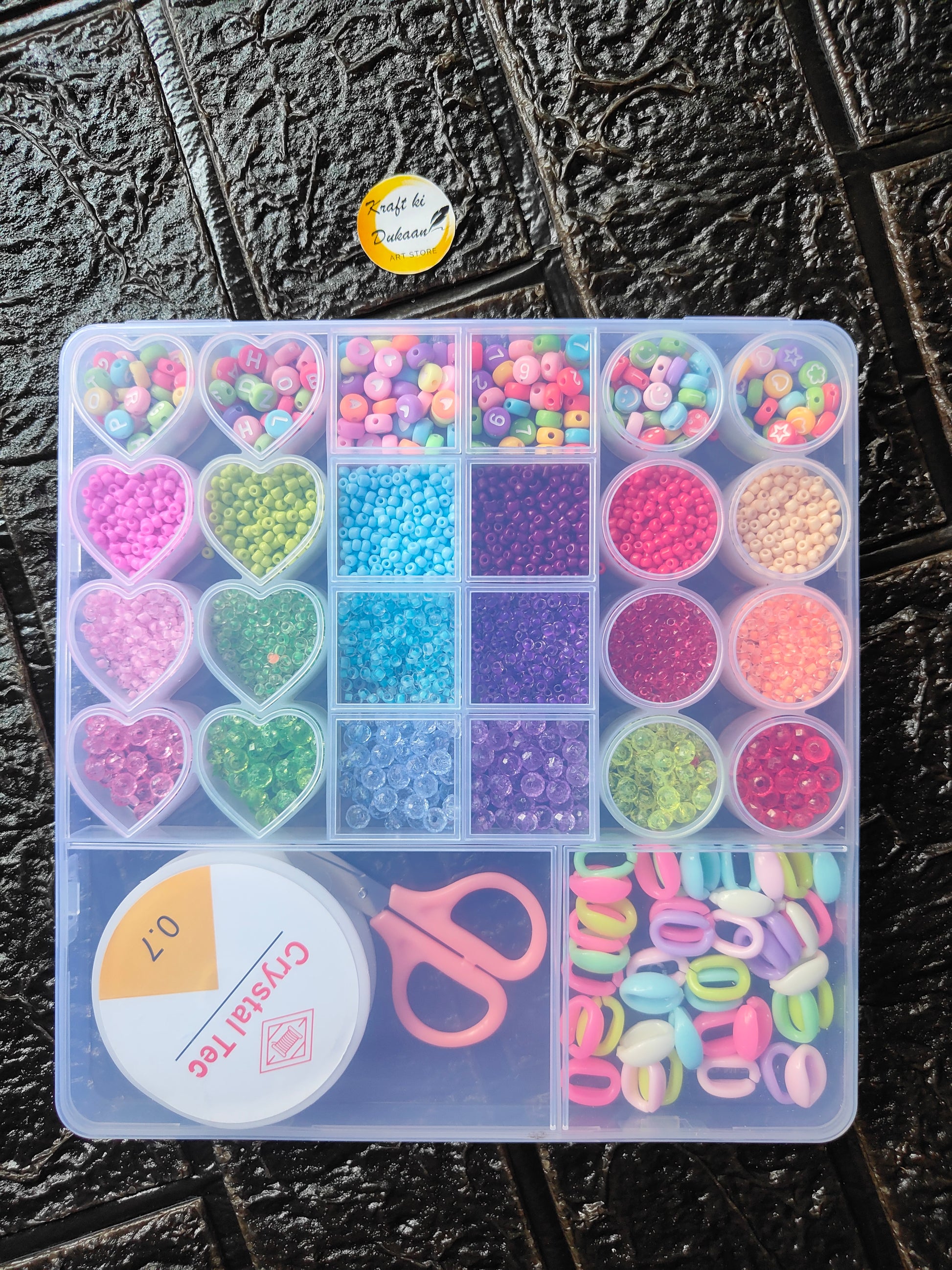 DIY bracelet beads kit tray with colorful beads, heart charms, and scissors