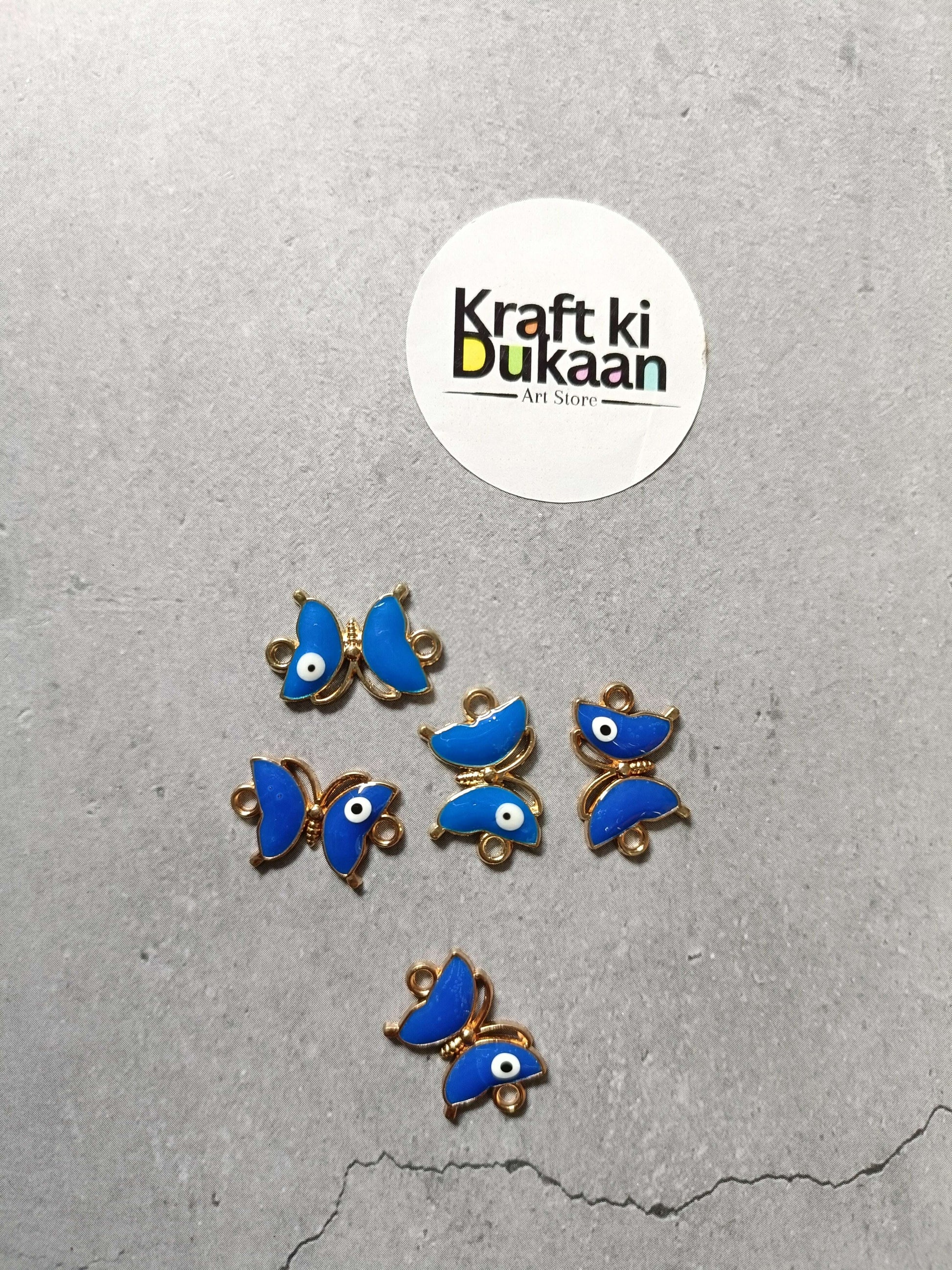 Blue enamel fish bracelet charms with gold-tone loops and white eye accents